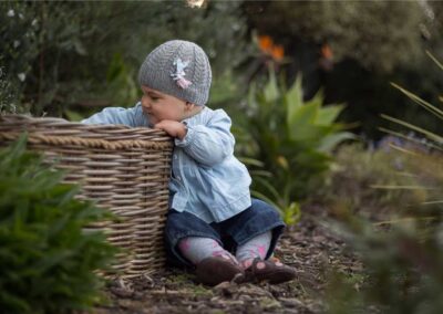 baby curiously looking in basket