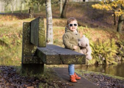 toddler girl in autumn forest