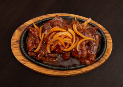 Top view of an oval shaped hot plate meal from Asian BBQ Noodle House. Professional Content, social media and food photography in Auckland, New Zealand.