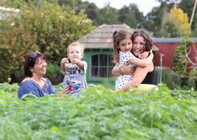 Happy family portrait with extended members. Outdoor family portrait photography in Auckland, New Zealand.