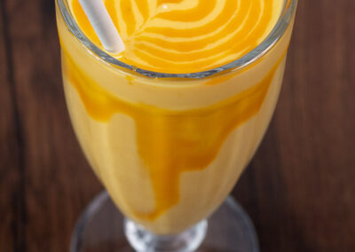 Mango smoothie with a straw. Professional Content, social media and food photography in Auckland, New Zealand.