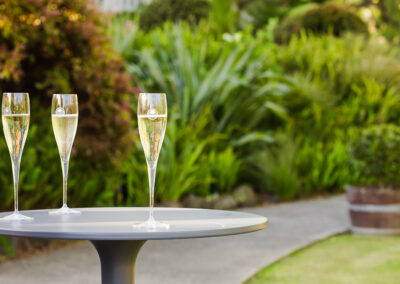 Three glasses of champagne placed on a bar table. Professional Content, social media and food photography in Auckland, New Zealand.