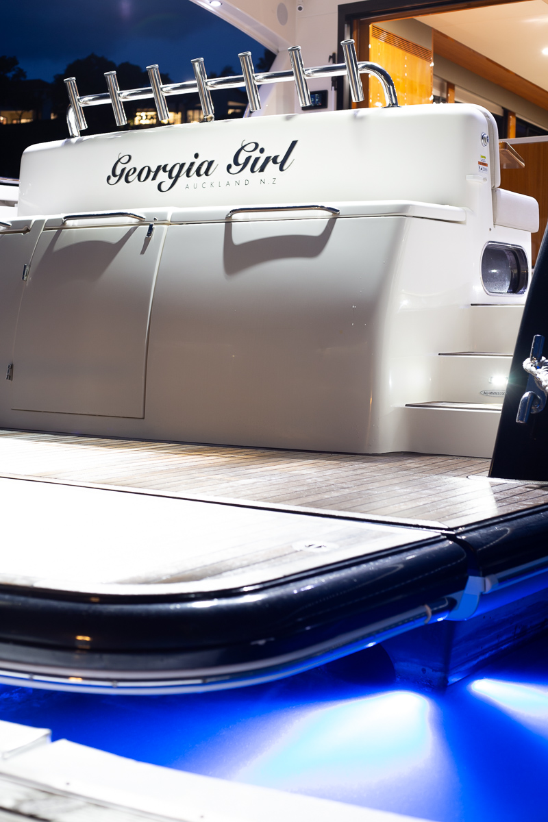 High end Yacht photo at night light up with blue light. in the marina. Professional real estate, interiors and boat photography in Whangaparaoa, Auckland, New Zealand.