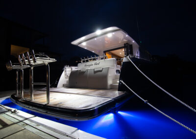 High end Yacht photo at night light up with blue light. in the marina. Professional real estate, interiors and boat photography in Whangaparaoa, Auckland, New Zealand.