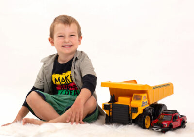 young boy with his cars ina studio portrait session, in Auckland New Zealand