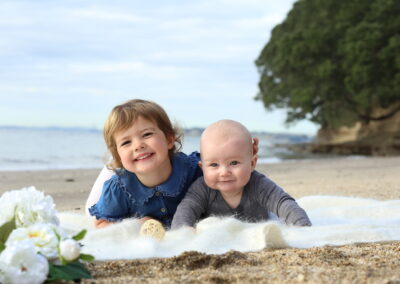 Sibling portrait on beach, Manly, Auckland