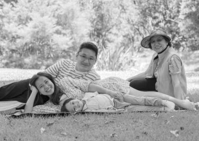 Professional Asian Family portrait with grandma, mum, dad and young child. Happy summer family portrait in an Auckland Garden, New Zealand.