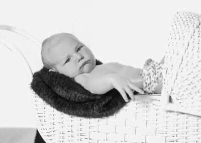 1 week old baby portrait in pram black and white studio newborn photography