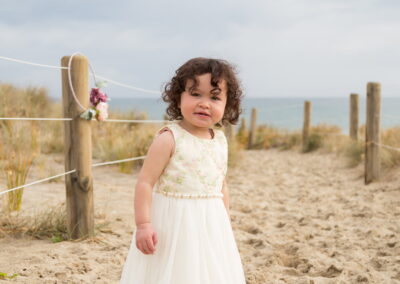 Toddler girl in pretty dress on the beach photography