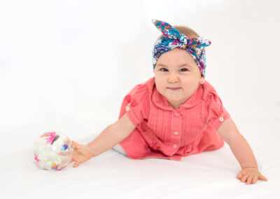 baby playing with ball in an auckland photostudio