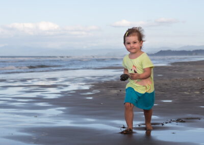 beach scene with toddler in new zealand