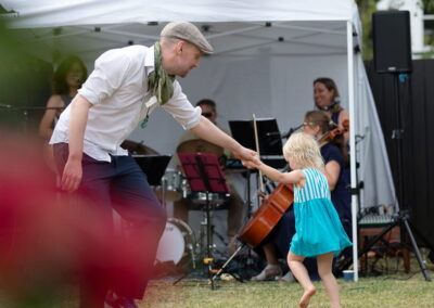 young man dancing with daughter at wedding