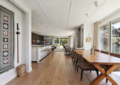 Dining and living area shot with wall hanging designer art piece