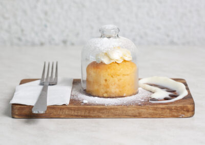 cake served in style under a glass lid