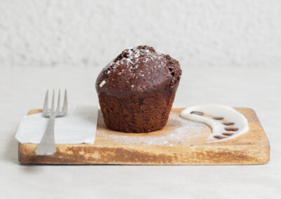side on styled food shot with chocolate muffin on board