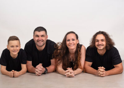 Family portrait fun lying on belly studio portrait