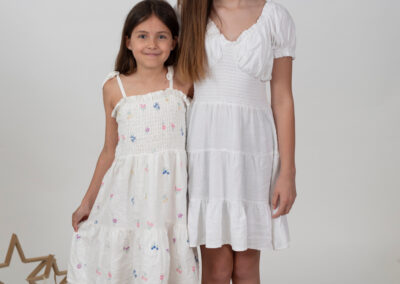 SIbling girls in clean chrip Christmas studio set