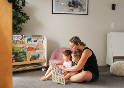 Inside of a daycare, teacher reading to children, light and airy high end photography
