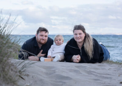 parents with baby on beach family portrait