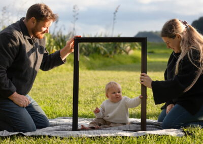 parents with baby boy on picnic mat