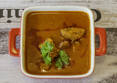 red curry in red dish top view