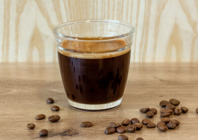 coffee in glass cup and spilled beans