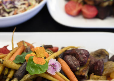 edible flower on yummy roasted veggies _professional food photography in lifestyle setting